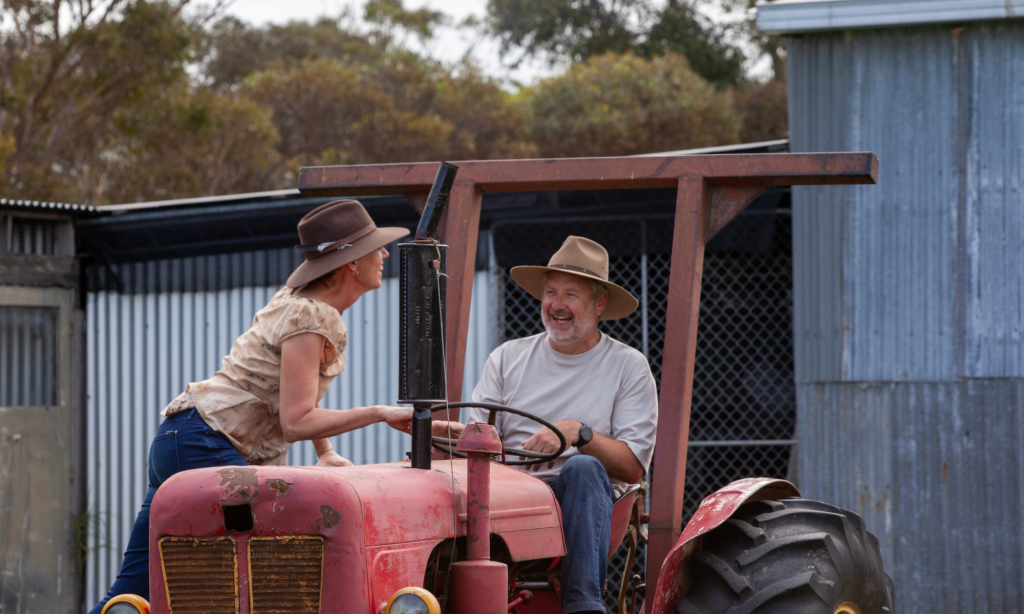 Photo of man and woman on vintage red tractor at Yintarini Farm