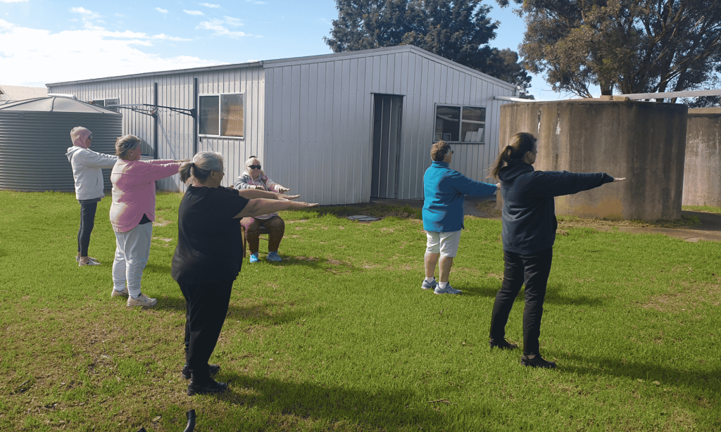 Group of people stretching outside