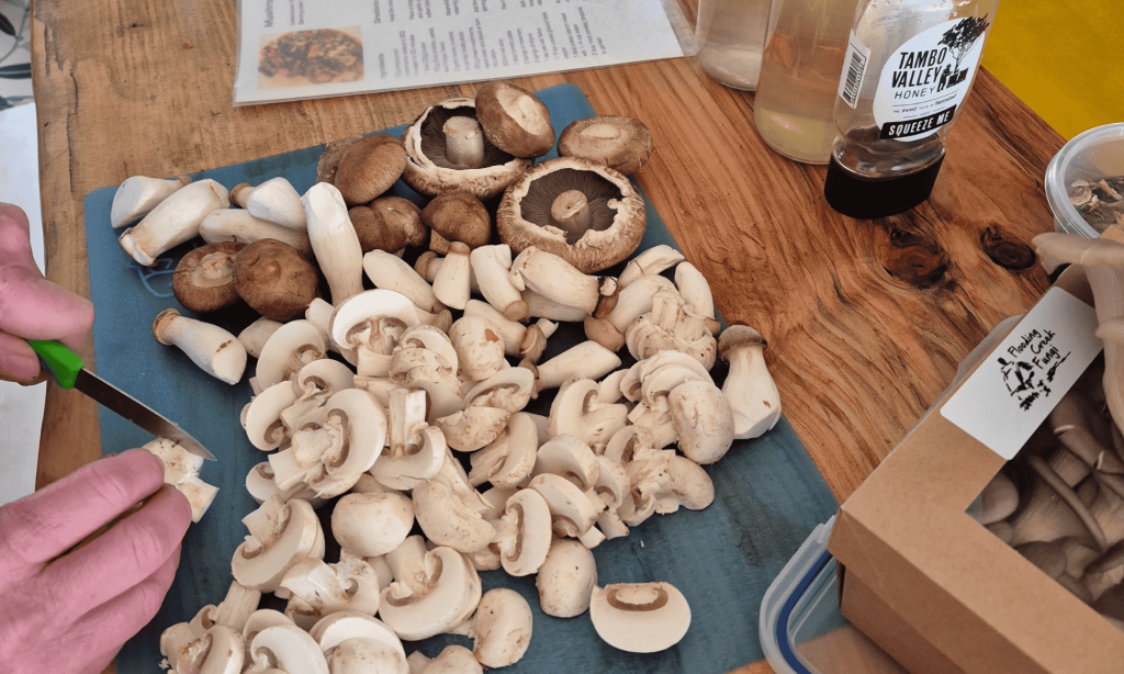 Person slicing mushrooms in the kitchen