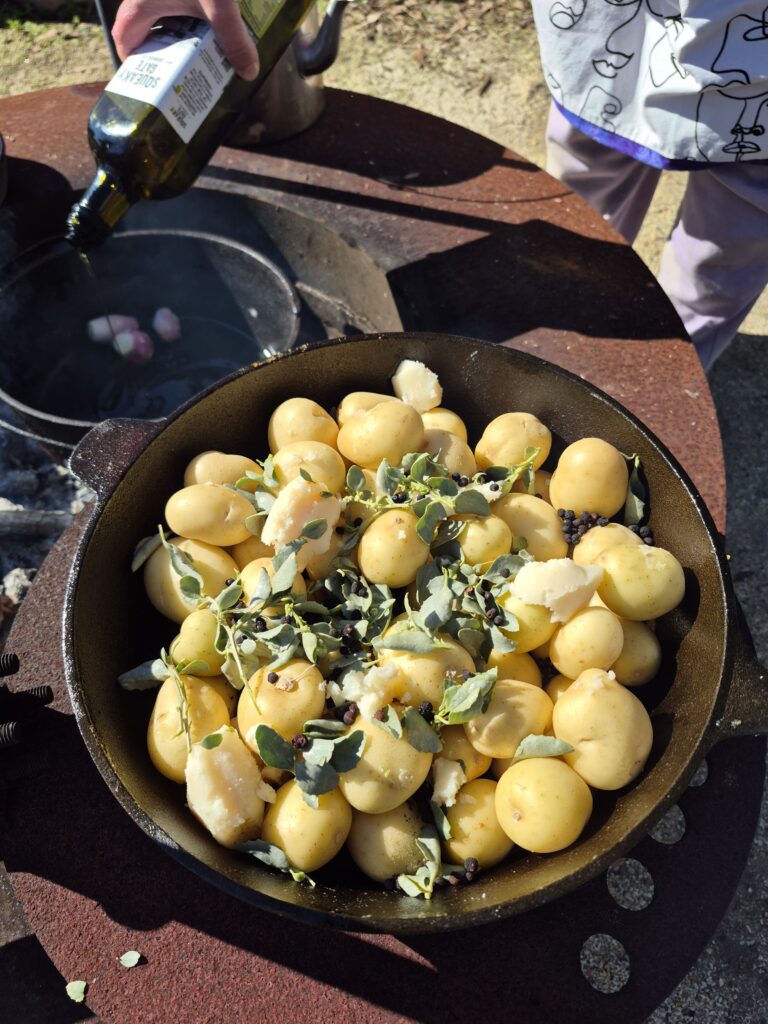 Chat potatoes with pepperberries and salt bush on the open fire